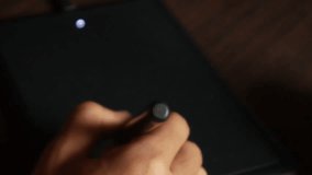 male designer using graphic tablet to retouch digital photos or drawings - Powered by Shutterstock - Get 15% off with code: PIKWIZARD15