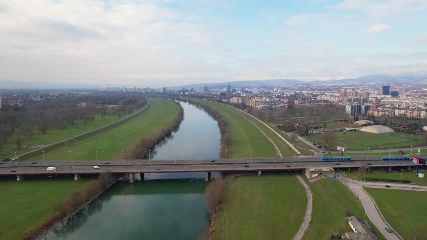 Panorama of the river Sava flowing through Zagreb the capital city of Croatia and a view of the famous Bridge of Youth with the trams and vehicles passing over it