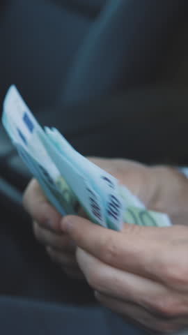 Vertical Format Video of Man hands while counting Euro money bills european economy value. Euro currency exchange. Cash money calculation. Businessman counting euro banknotes.