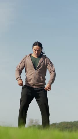 An Athletic Man Engaging in Squats while Surrounded by the Beautiful Nature Landscape