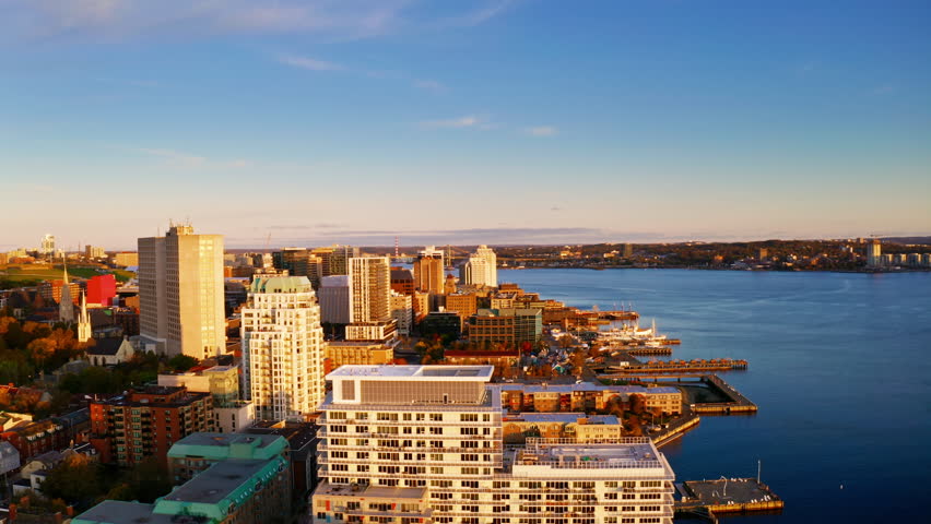Sunrise aerial drone shot over Halifax downtown, Nova Scotia, Canada.
High view of the golden landscape and sea at down as the sun is rising in the early morning.