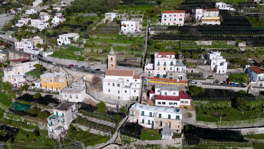 drone fly close to the old church in the Amalfi village town in south Italy , picturesque European travel destination