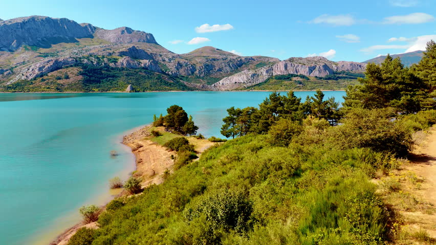 Spectacular nature of the national park in Leon, Spain, Europe. Aerial view on the turquoise lake at the foot of the picturesque mountains.
