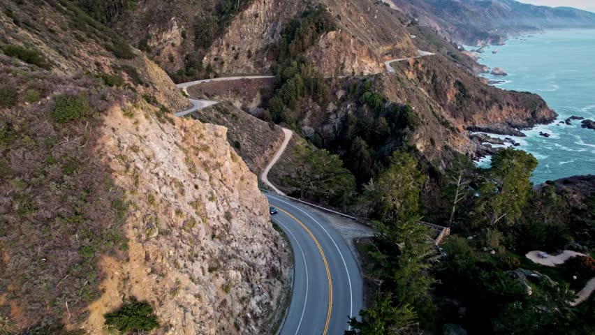 Epic Drone View of California’s Pacific Coast Highway Winding Along Steep Cliffs and Ocean