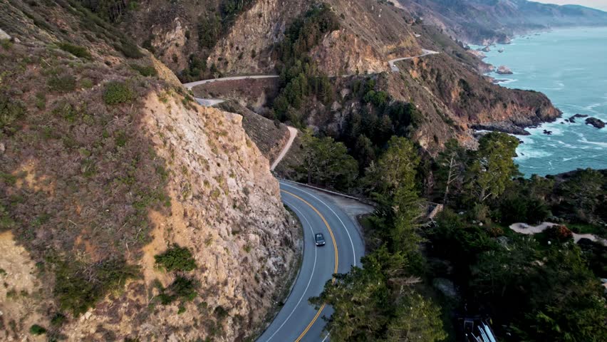 Epic Drone View of California’s Pacific Coast Highway Winding Along Steep Cliffs and Ocean