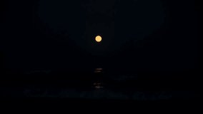 Lunar Glow on Ocean Waves – A striking red moon emerges over the vast ocean, illuminating the gentle movement of the water under the night sky - Powered by Shutterstock - Get 15% off with code: PIKWIZARD15