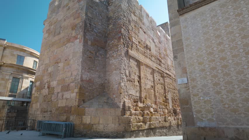 Ancient stone tower in Tarragona, Spain, showcasing medieval architecture under a bright sky