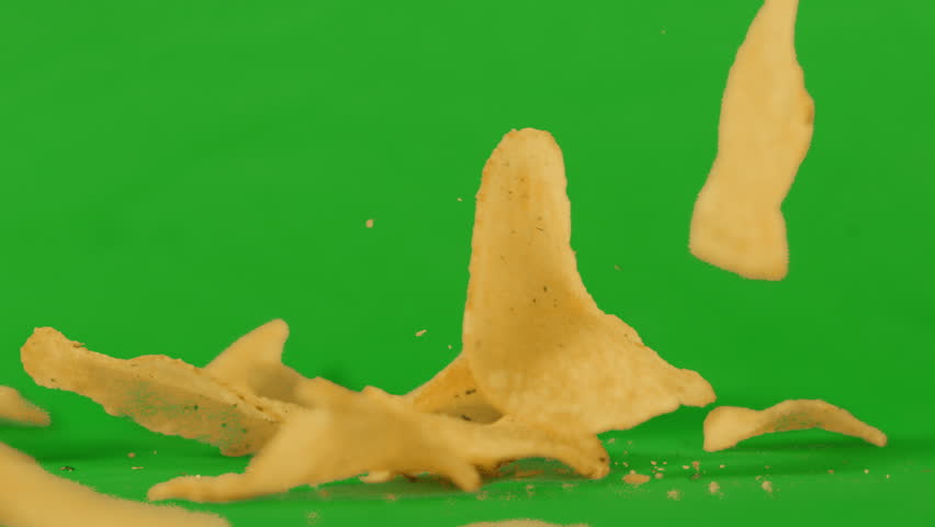 Potato Chips Crisps Falling in Slow Motion on Green Screen Background. Unhealthy Ultra Processed Food Footage Ready to Key. ProRes 4K.
