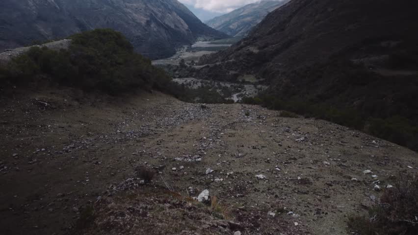 Reveals Mountain And Clouds Over Hiking Trails Of Peru. Tilt-up Shot