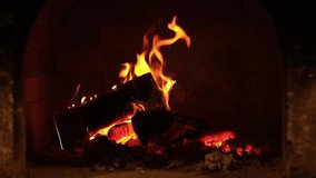 Cozy fireplace burning logs in a brick hearth during the evening hours creating a warm atmosphere for relaxation - Powered by Shutterstock - Get 15% off with code: PIKWIZARD15