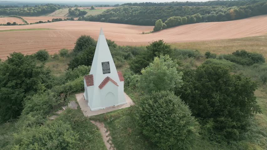 Aerial view orbiting Farley mount monument horse burial marker on Hampshire country park hill