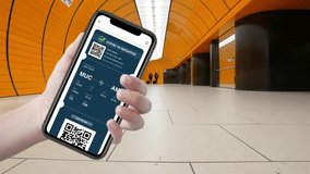 A person holds a digital COVID-19 vaccination certificate on their smartphone in an airport environment, showcasing important travel information like a QR code and negative test status. - Powered by Shutterstock - Get 15% off with code: PIKWIZARD15