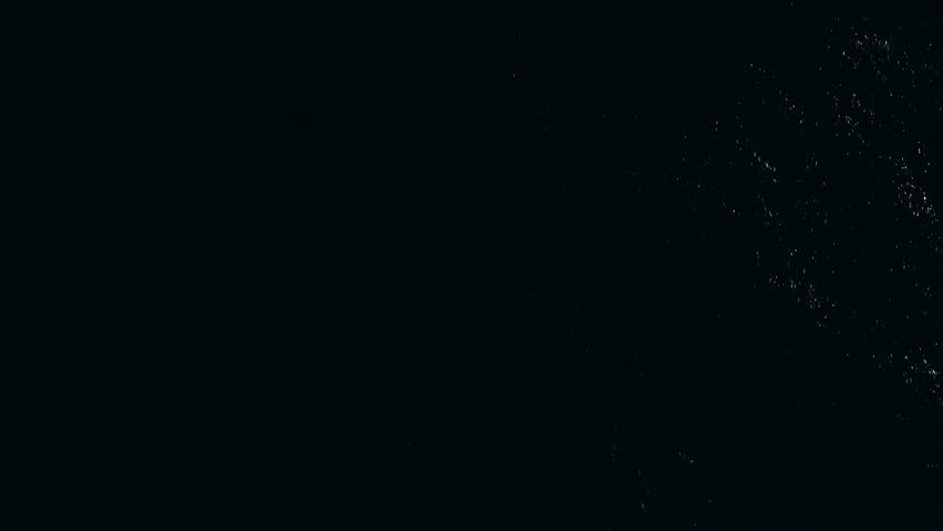 Aerial view of deep, dark ocean water with faint waves and scattered reflections, creating a mysterious and moody atmosphere.