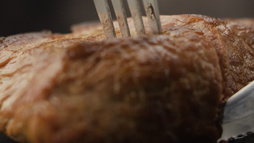 Macro shot of delicious meal juicy grilled steak cut on wooden board. food and drink concept