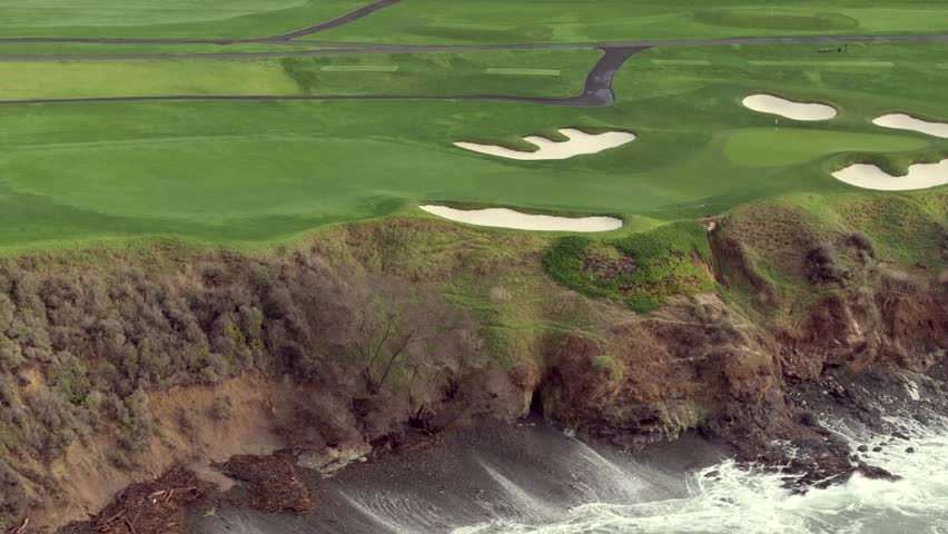 Golf course overlooking the ocean with sand bunkers near a cliff at Pebble Beach