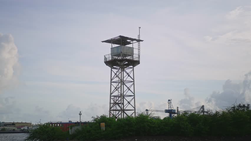 A watchtower stands tall as it slowly drifts past, framed against the open sky and the vast, endless horizon.