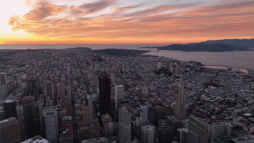Aerial view of San Francisco toward Pacific Ocean and Golden Gate Bridge at sunset