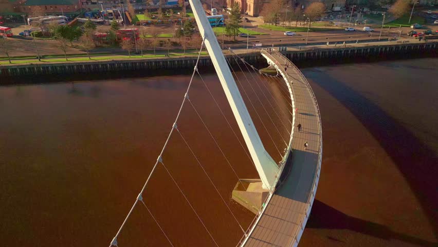 Ascending aerial shot of the Peace Bridge in Derry-Londonderry. Filmed on a sunny day in 4K, 60 frames per second and in Rec709 color.
