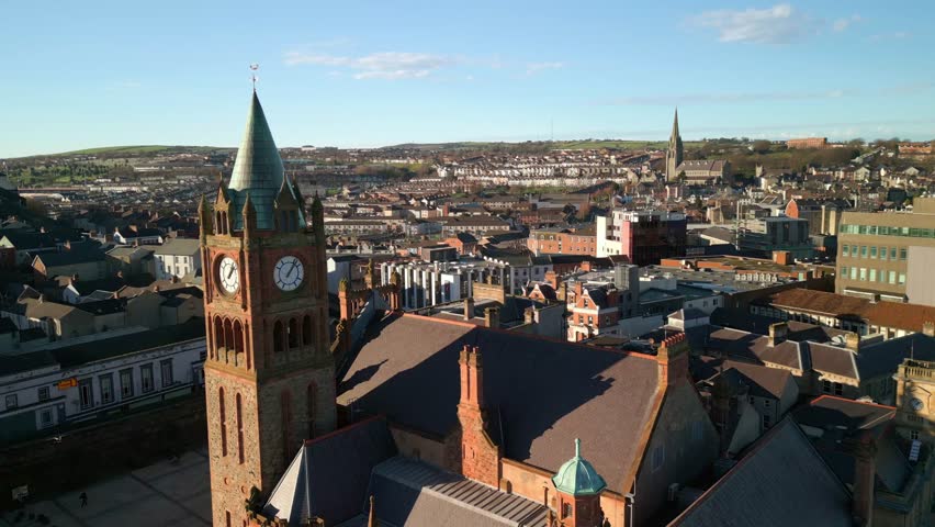 Reversing aerial of the Guildhall in Derry-Londonderry in Northern Ireland. Beginning at the clock tower, the camera reveals the River Foyle and Peace Bridge. Filmed in 4K, 60fps with Rec709 color.