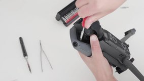 Repair techniques for drones focusing on disassembly and parts replacement in a workshop setting - Powered by Shutterstock - Get 15% off with code: PIKWIZARD15