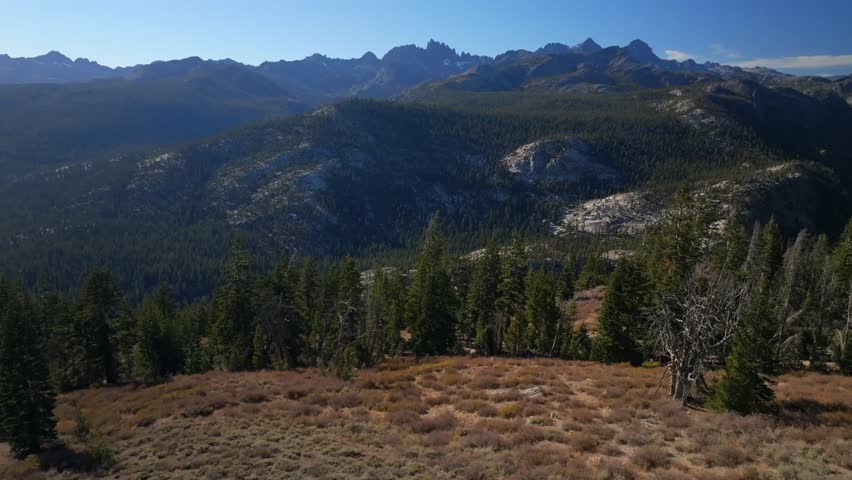 Minarets Vista Mammoth Mountain Lakes aerial drone California Sierras Banner Peak PCT Trail afternoon morning blue sky clouds nature landscape Pacific Crest Trail Yosemite forward pan up