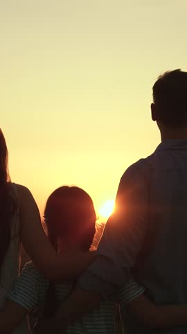 Family, hugs in nature sunset. Family mom dad child girl hugging, silhouette. Caring parents. Happy father mother, little daughter hugs in park, Close-up. Family in nature parents with child daughter
