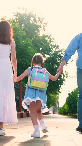 Mom dad child cheerfully running street. Parents child hurry to school, city street. Family teamwork. Daughter schoolgirl. Happy family. Mother father child running through park. Happy family playing.