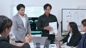 Professional business team analyzing financial data during collaborative meeting, discussing charts and graphs on monitor in modern corporate office environment - Powered by Shutterstock - Get 15% off with code: PIKWIZARD15