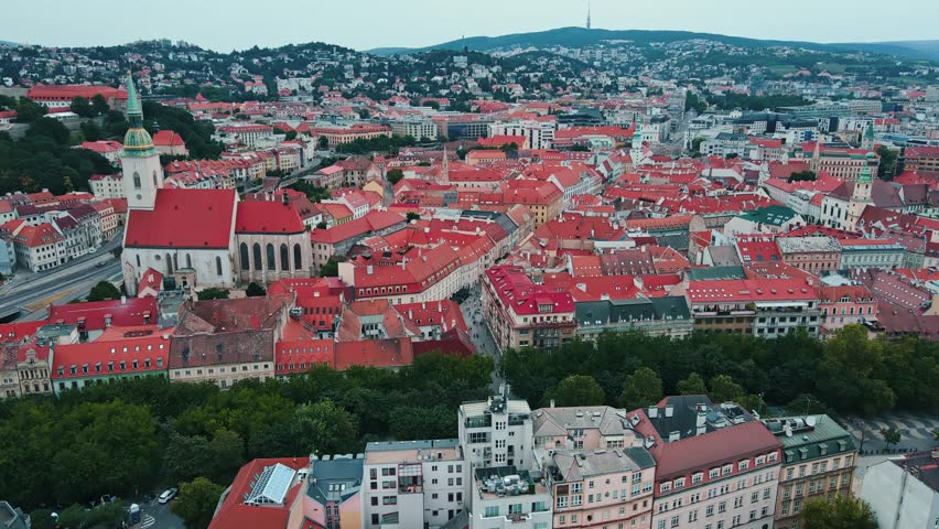 Panoramic aerial view of Bratislava, Slovakia. Historic old town of European city with red-roofed buildings and St Martins Cathedral surrounded by hills