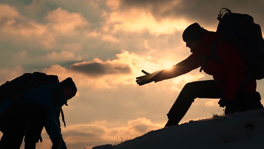 Go towards your goal. Travelers climb one after another on rock Climbers silhouettes stretch their hands to each other climbing to top of hill. Teamwork of business people. Team of businessmen victory