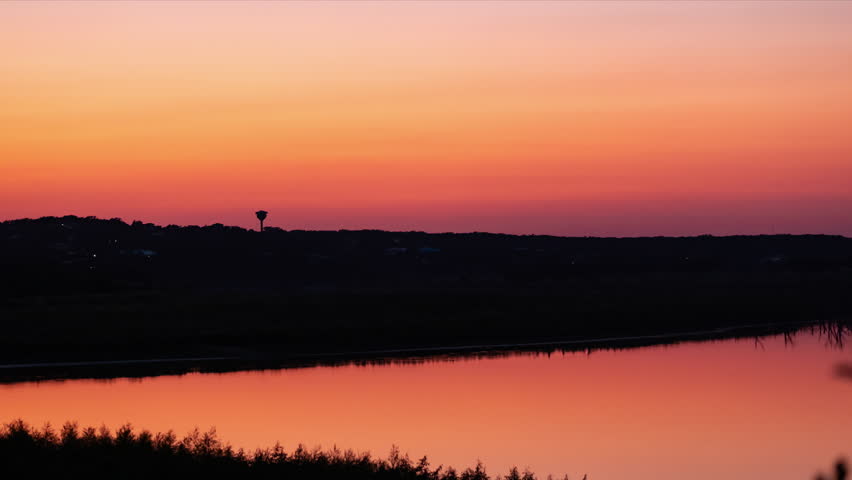 Dramatic, colorful Timelapse of the twilight just after sunset in canon lake, Texas in the hill country