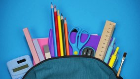 From the school bag appear notebooks, pencils and pens and other school supplies. Back to school concept. Stop motion - Powered by Shutterstock - Get 15% off with code: PIKWIZARD15