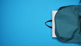 Stop motion animation of colorful school supplies moving to school bag on blue background. Back to school concept. Top view - Powered by Shutterstock - Get 15% off with code: PIKWIZARD15