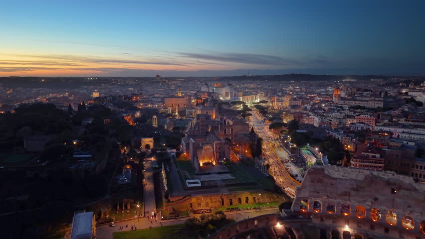 4k Aerial view of old city center, Illuminated houses after sunset. Rome, Italy.