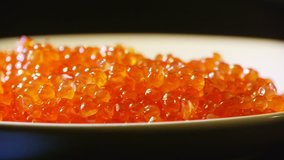 Red caviar on a white plate