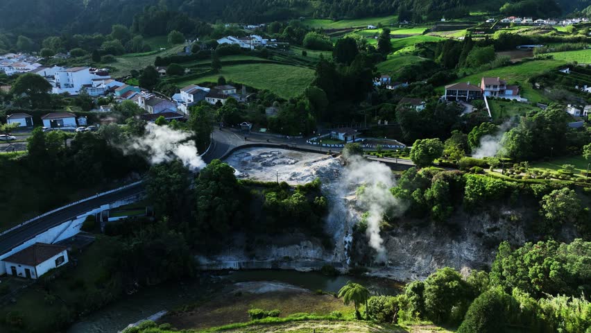 Steaming volcanic landscape in Furnas village with mineral hot springs, aerial