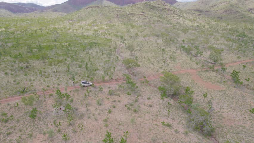 4WD Truck Drive Through Unpaved Rural Road In Pilbara, Western Australia. Aerial Shot
