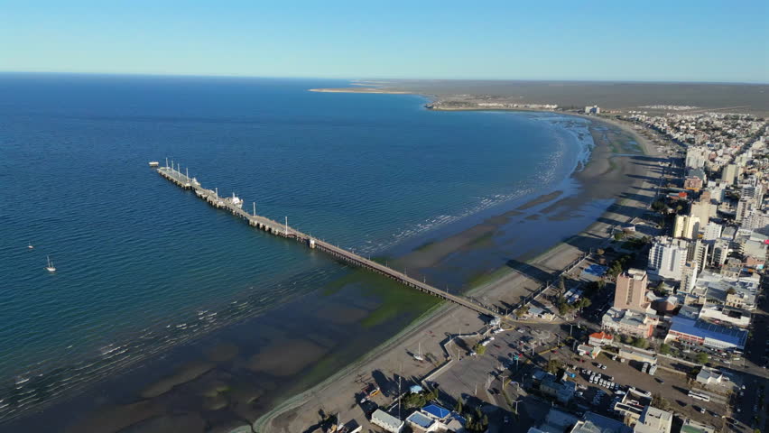 The Muelle Comandante Luis Piedra Buena, pedestrian tourist promenade in the city, shore, ocean, sea, pan shot with copy space