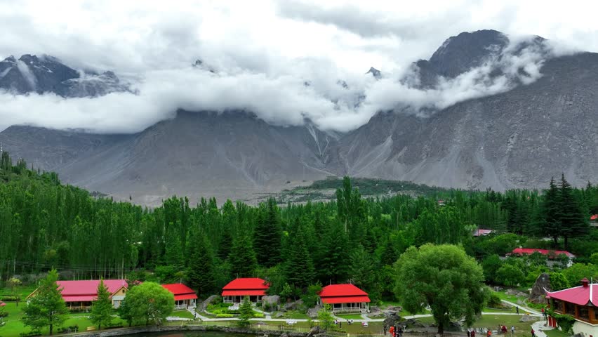 Beautiful landscape showing Shangrila Resort reflecting on Lower Kachura Lake with cloudy mountains in the background, Skardu Valley, Pakistan