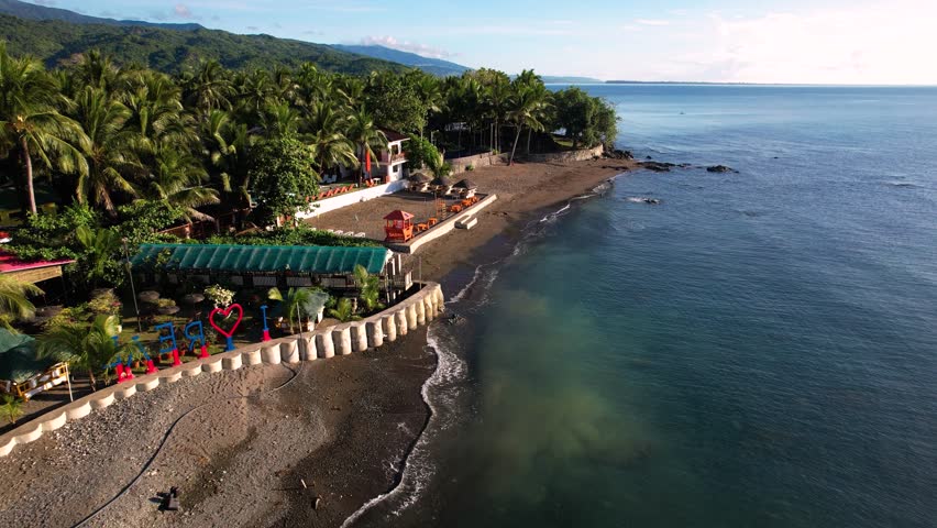 Aerial of the coastline surrounded by mountains along the town of Real, Quezon Province, Philippines.