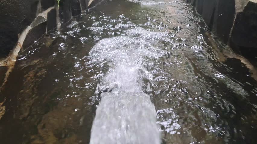 water fountain flowing into the pool