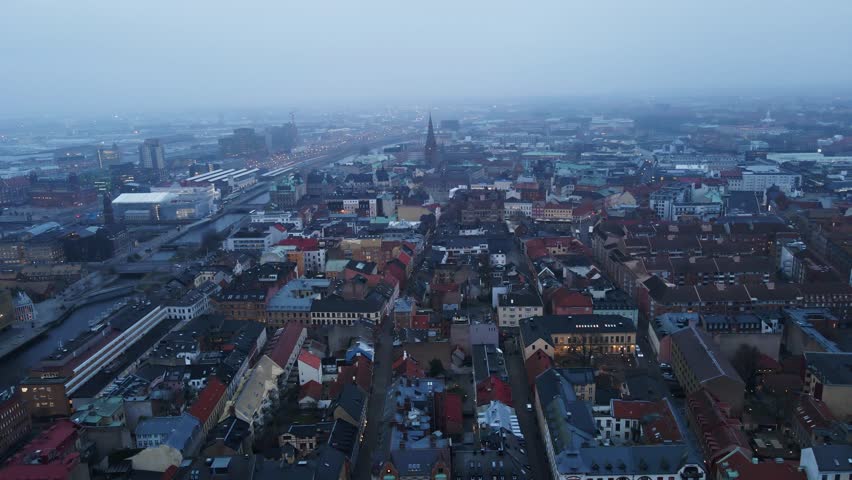 Beautiful aerial dolly of Malmö city skyline on a foggy morning in Sweden