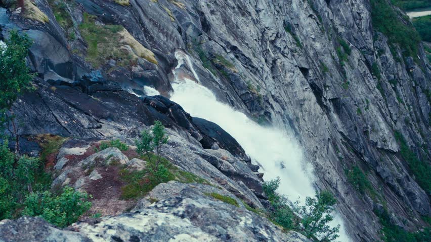 Waterfall Cascading Down Cliffs In Rago National Park, Norway - Panning Shot