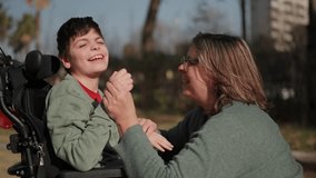 Disabled child sharing a moment of joy with his mother in the park - Powered by Shutterstock - Get 15% off with code: PIKWIZARD15