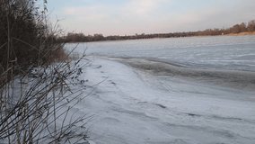 : ice on the river. Ice floating slowly down the river in spring. River with floating frozen blocks of ice. Snowdrifts and trees in frost on the shore. ice on the river.  video 4k - Powered by Shutterstock - Get 15% off with code: PIKWIZARD15