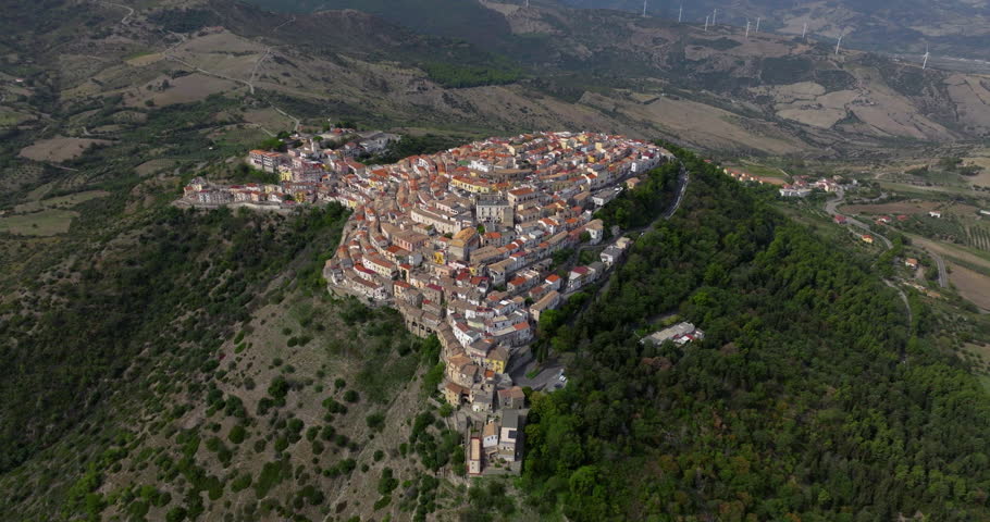 Italian Hilltop Village Of Rotondella Town Surrounded By Lush Greenery In Matera, Basilicata, Italy. Aerial, Tilt-down Shot