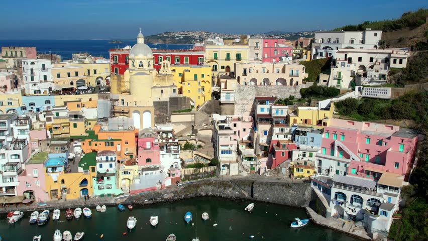Italy travel and landmarks. Most scenic and colorful island - beautiful Procida in gulf of Naples. Port of Corricella . aerial 4k hd drone video
