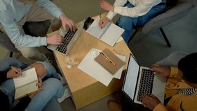 Students collaborating on projects in a cozy study space with laptops and notebooks - Powered by Shutterstock - Get 15% off with code: PIKWIZARD15
