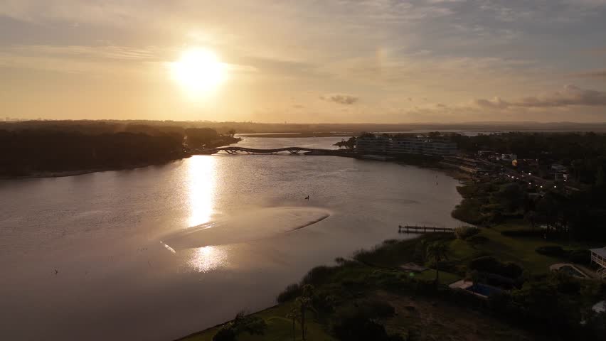 Lionel Viera Bridge or Puente de la Barra, Maldonado Creek, Punta del Este in southern Uruguay. Aerial forward at sunset, copy space