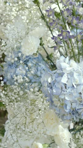 wedding arch of white rose flowers on the river bank before the wedding ceremony of the bride and groom, festive romantic decor
